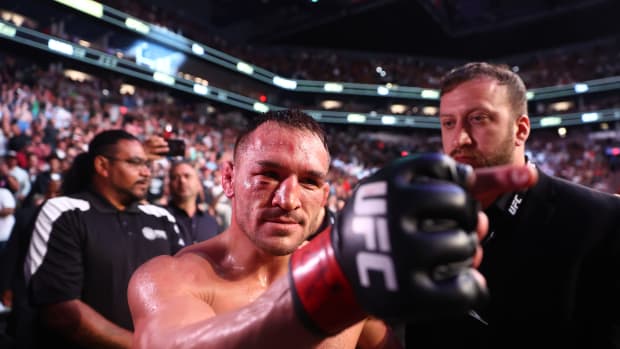 Michael Chandler celebrates his knockout victory against Tony Ferguson during UFC 274 at Footprint Center.